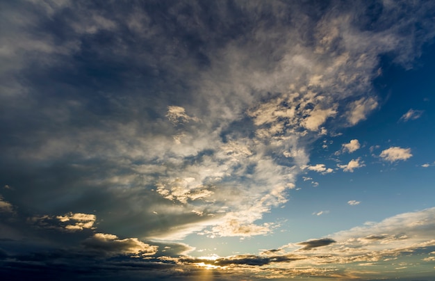 Fantastic panorama view of bright white gray dark wide puffy clouds lit by sun spreading against deep blue sky moving with wind. Beauty and power of nature, meteorology and climate changing concept.