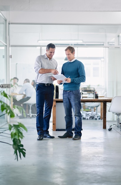 Fantastic stuff Shot of two colleagues having a discussion in the office