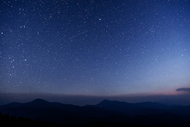 Fantastic winter meteor shower and the snow-capped mountains.