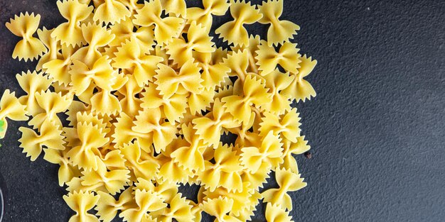 Farfalle bows pasta raw meal food copy space food background rustic