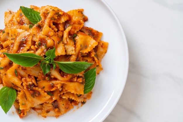 farfalle pasta with basil and garlic in tomato sauce - Italian sauce