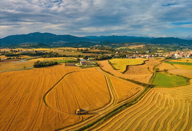 A farm is surrounded by a field of wheat.