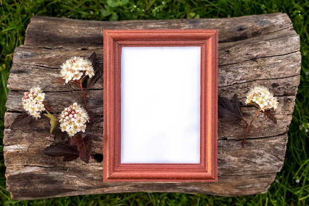 Farm mockup wooden frame and flowers on natural wood background