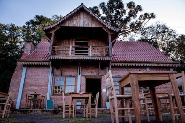 Farm in southern Brazil wooden hut and Araucaria trees in the background