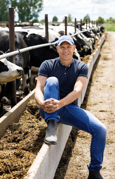 Farmer at farm with dairy cows