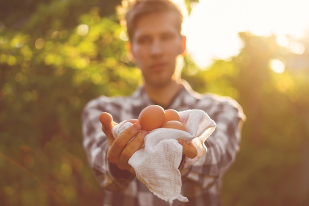 Farmer's hands holding some natural eggss