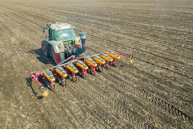 Farmer seeding crops at field. Seeding Aerial View.