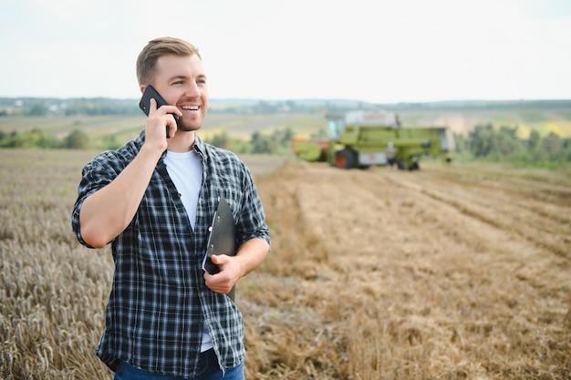 Farmer Standing In Wheat Field At Harvest