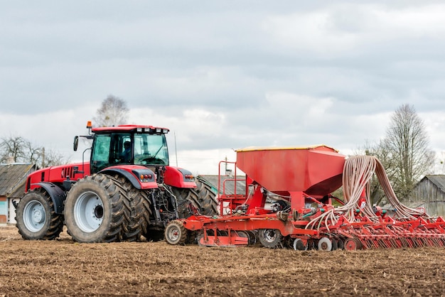 Farmer tractor working in the field Spring time for sowing Planting crops