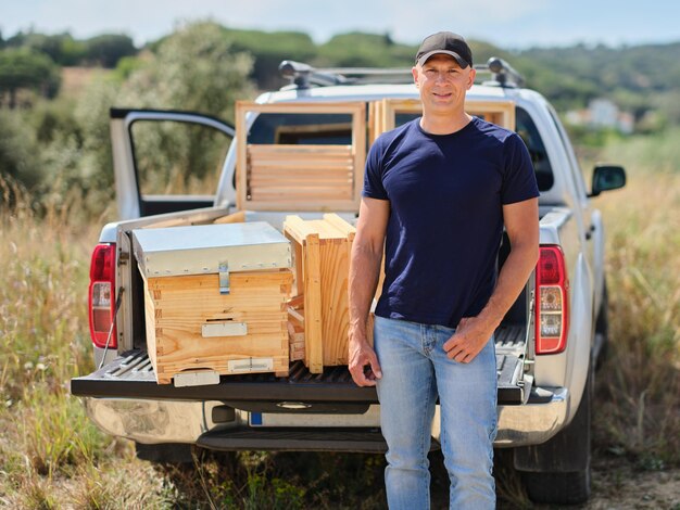 farmer with new beekeeper near the car