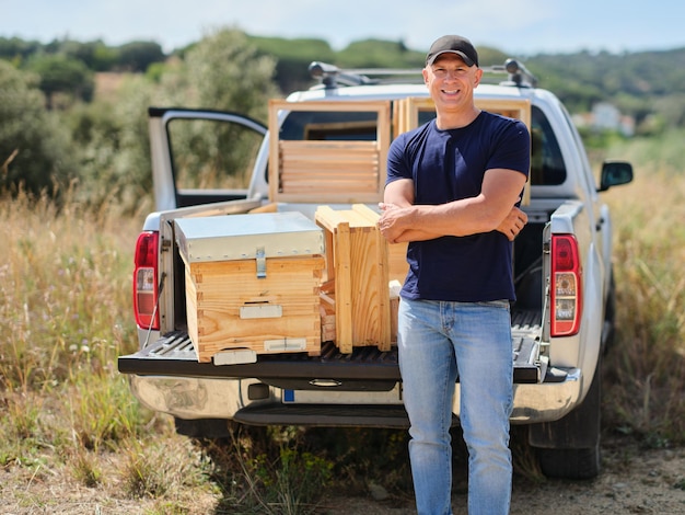 farmer with new beekeeper near the car