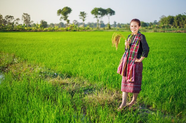 farmer woman holding rice in field