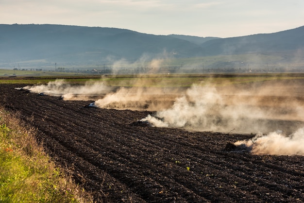 Farmers burn the dry grass and straw stubble on field in autum, another cause of global warming.