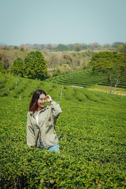 Farmers girl into tea farm field.