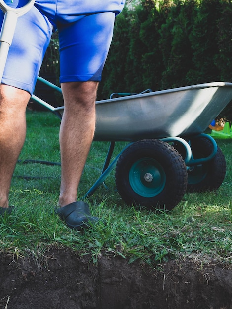 Farming gardening agriculture and people concept man with shovel digging garden or farm