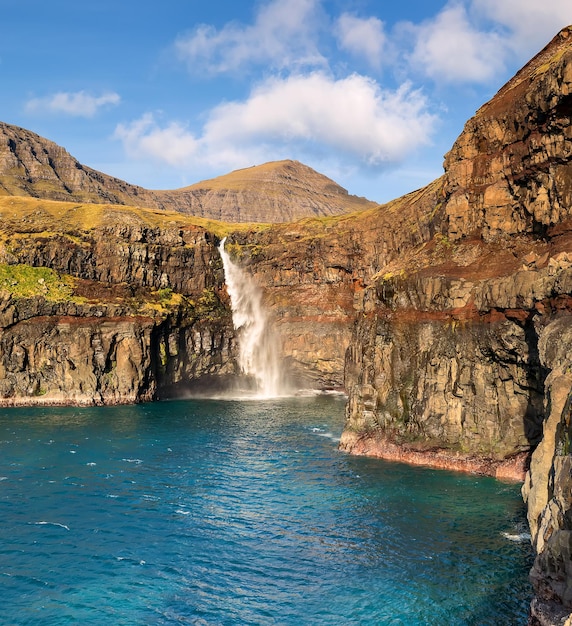 Faroe islands Vagar Island and the famous Mulafossur waterfall Atlantic Ocean Denmark