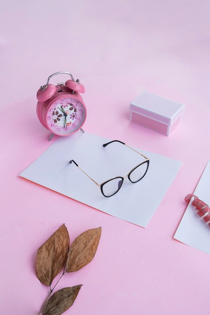 Fashion and beauty concept lying flat with square glasses women's accessories on pink background