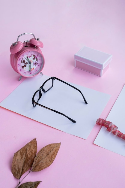 Fashion and beauty concept lying flat with square glasses women's accessories on pink background