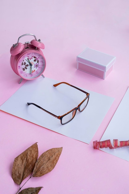 Fashion and beauty concept lying flat with square glasses women's accessories on pink background