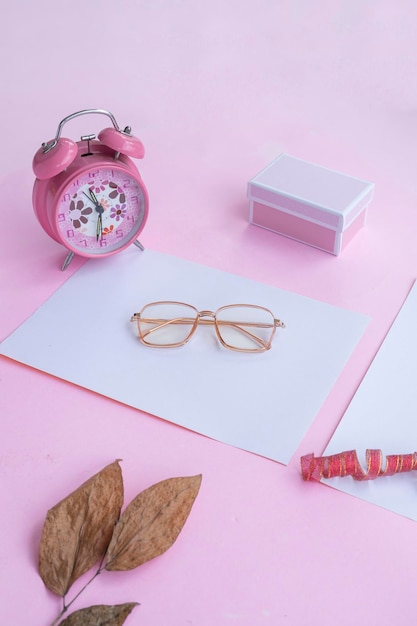 Fashion and beauty concept lying flat with square glasses women's accessories on pink background