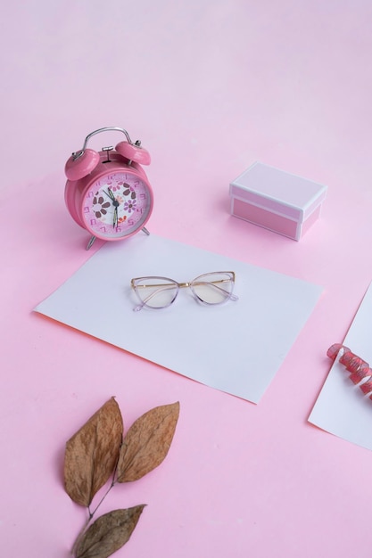 Fashion and beauty concept lying flat with square glasses women's accessories on pink background