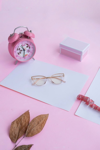 Fashion and beauty concept lying flat with square glasses women's accessories on pink background