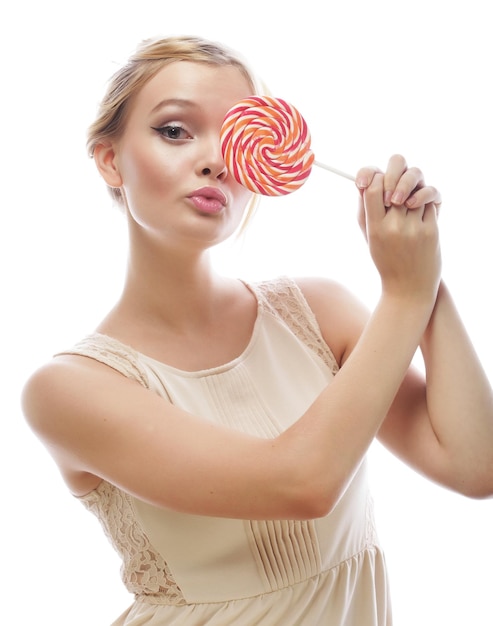 Fashion blond woman holding lollipop