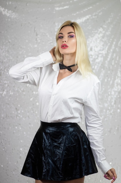 fashion blonde model woman in white shirt and black skirt