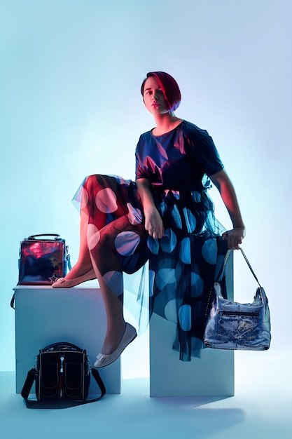 Fashion children pose with a collection of bags and clutches