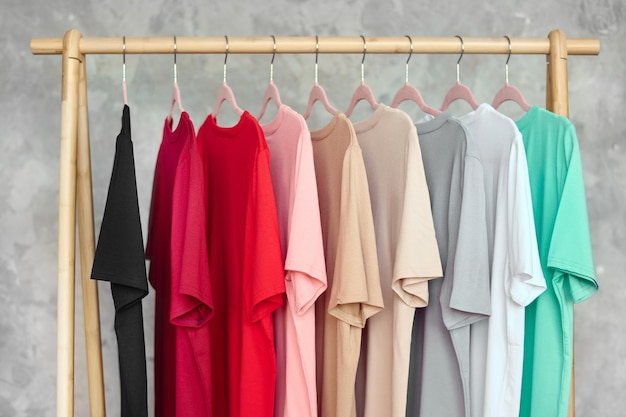 Fashion clothes on clothing rack  bright colorful closet Closeup of rainbow color choice of trendy female wear on hangers in store closet or spring cleaning concept Summer home wardrobe