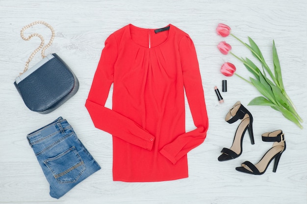 Fashion concept. Red blouse, shoes,  handbag and pink tulips. Top view