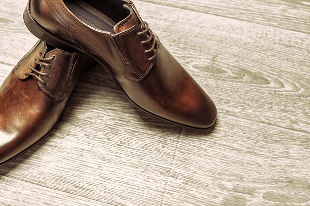 Fashion concept with male shoes on wooden table