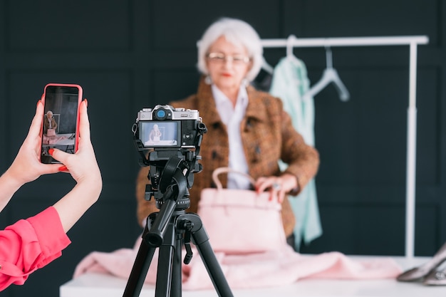 fashion consultant in showroom. senior trendy woman. personal stylist at work