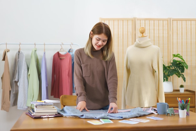 Fashion design concept Fashion designer measuring size of shirt to checkup before sending customer