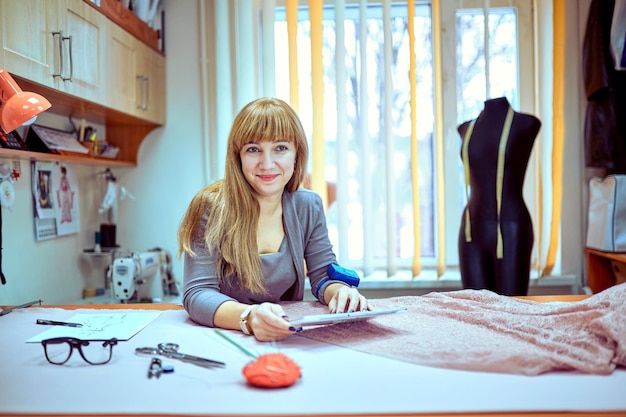 Fashion designer looking at sketches in studio