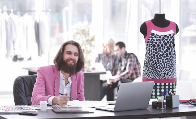 Fashion designer at the table in a modern Studio