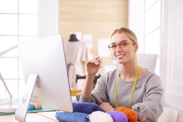 Fashion designer using tablet computer in the studio