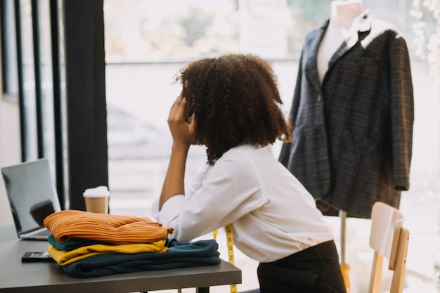 Fashion designer woman working on her designs in the studio