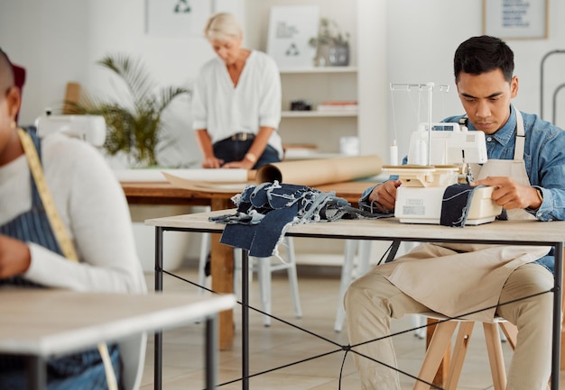 Photo fashion designer young man and creative student in a workshop to stitch clothes factory worker tailor and apprentice learning sewing machine skills in a textile startup and manufacturing studio