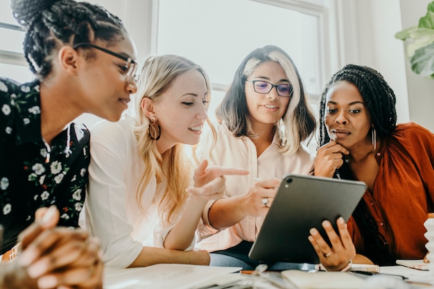 Fashion designers having a meeting using a digital tablet