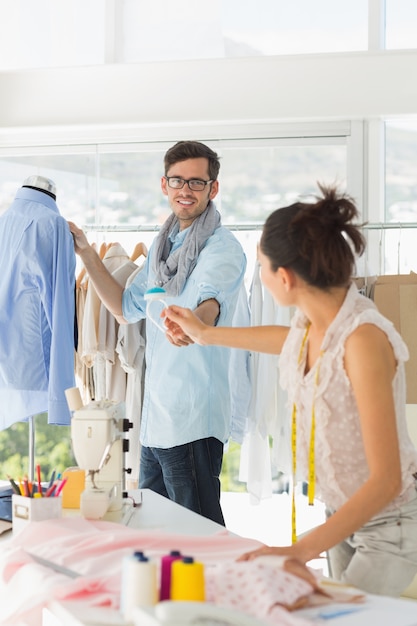 Fashion designers at work in bright studio