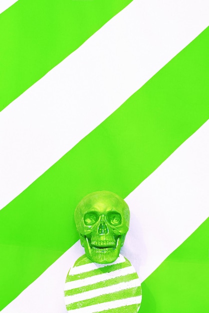 Fashion green skull in geometry space Holiday halloween New year's party concept Stylish still life minimal scene