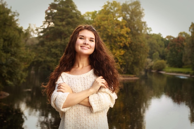 Fashion happy woman near the river