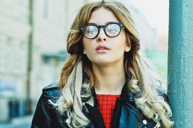 Fashion hipster portrait of young beautiful blonde woman posing outdoor in summer