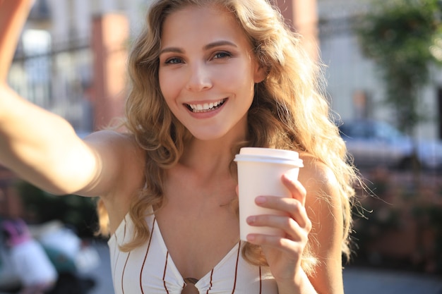 Fashion lifestyle portrait pretty woman posing in the city summer, street fashion.