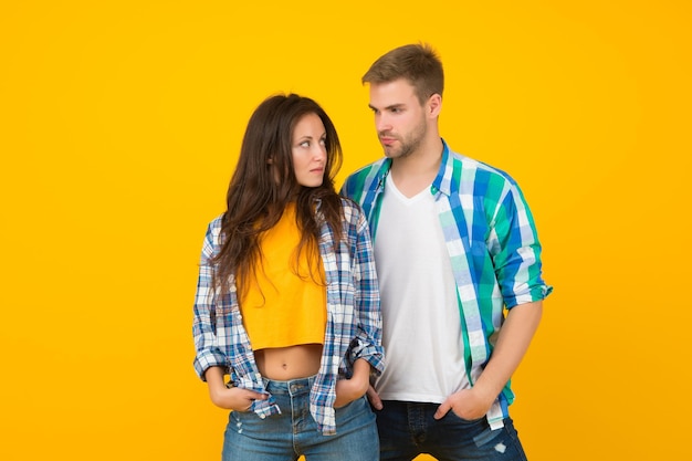 Fashion look of romantic couple in love yellow background relationship