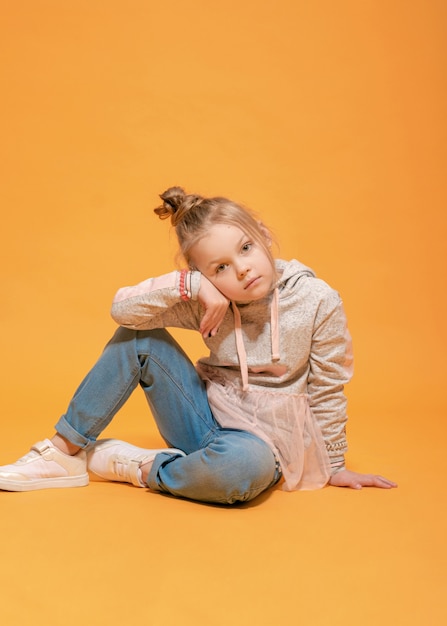 Fashion model beautiful girl on a yellow background