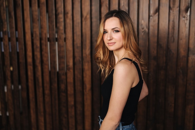 Fashion model in denim and black t-shirt in studio