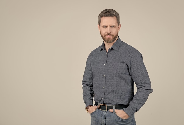 Fashion model wear stylish shirt with casual jeans posing with arms in pockets wardrobe copy space