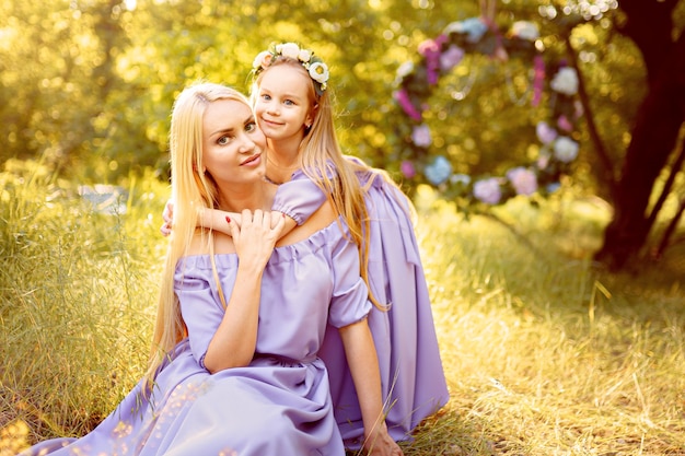 Fashion outdoor photo of beautiful family look beautiful mother